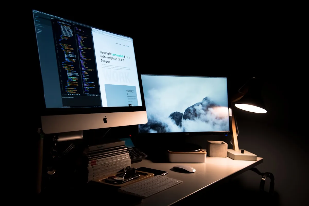 Desktop computer displaying a colourful website design layout on a work desk
