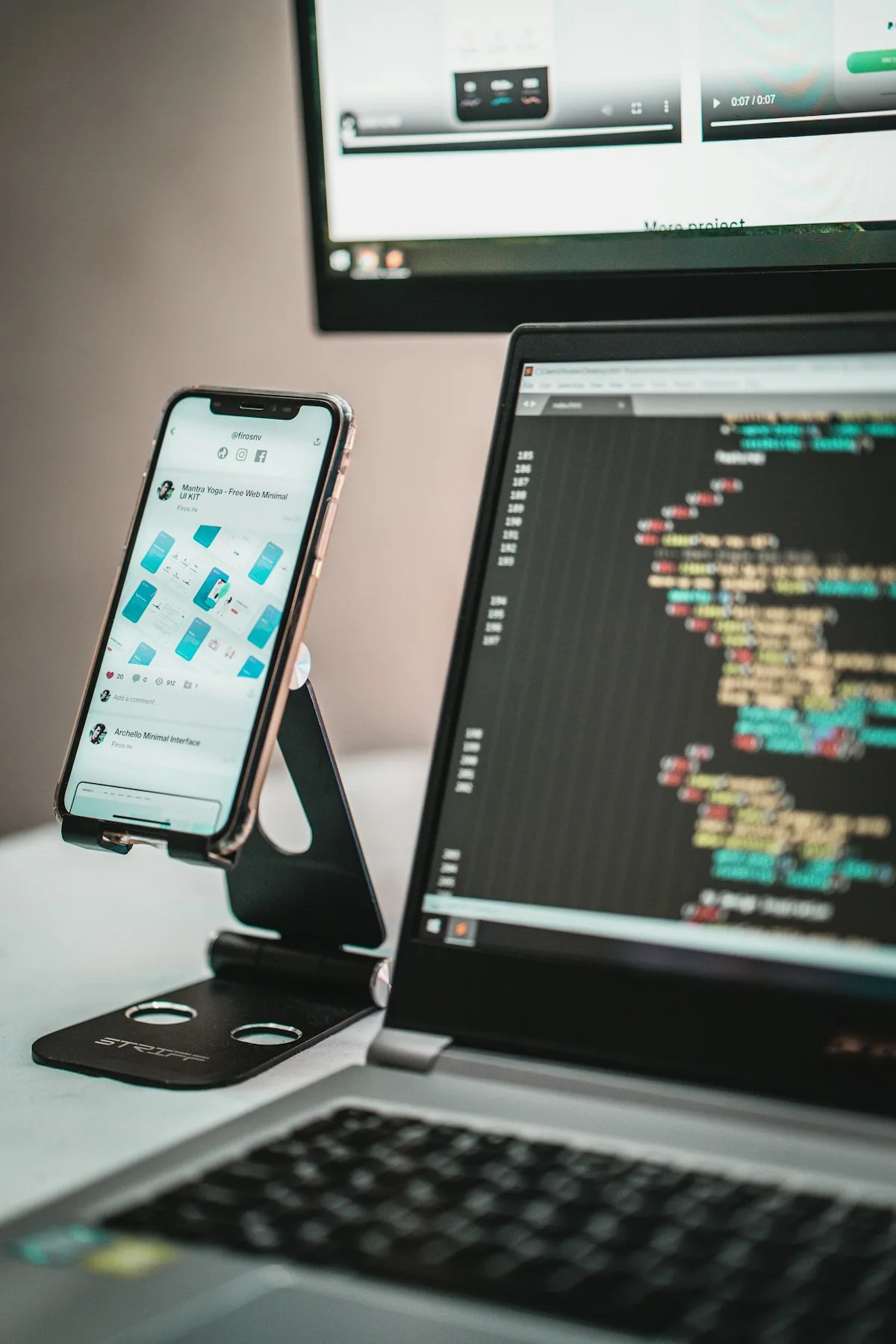 Android smartphone placed next to a laptop, comparing old and new device experiences